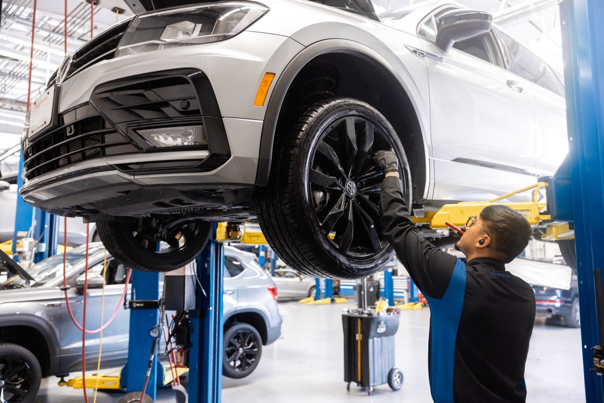Volkswagen technician servicing an SUV